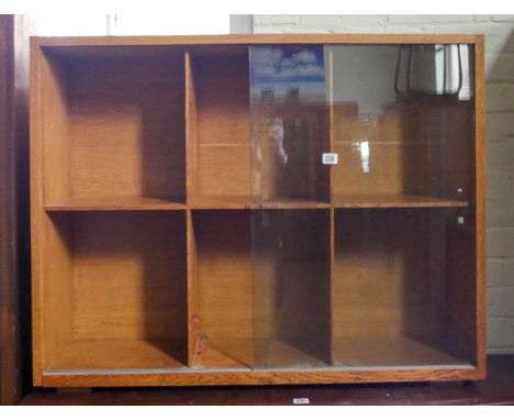 A light oak bookcase with sliding glass doors, 3'3 wide 