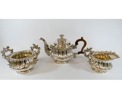 A good quality three piece silver plated tea service with ornate form with wooden handle and rose finial 