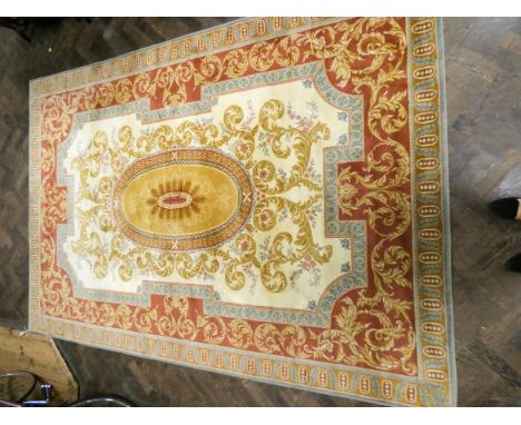 A cream and patterned Wilton style carpet, approximately 9'9 X 6'9