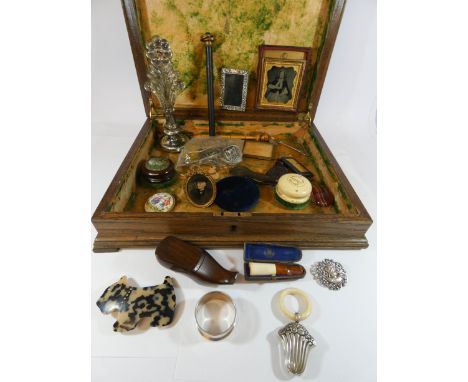 An old cutlery box containing teething rattle, napkin ring, brooches, snuff shoe, picture frames, white metal brooches etc 