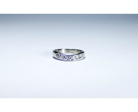 18ct white gold diamond set wedding band, channel set with seven brilliant cut diamonds, ring size K/L, weight 3.3 grams