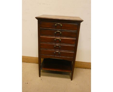 An Edwardian mahogany music cabinet, fitted five drawers with shelf under, 21" wide 