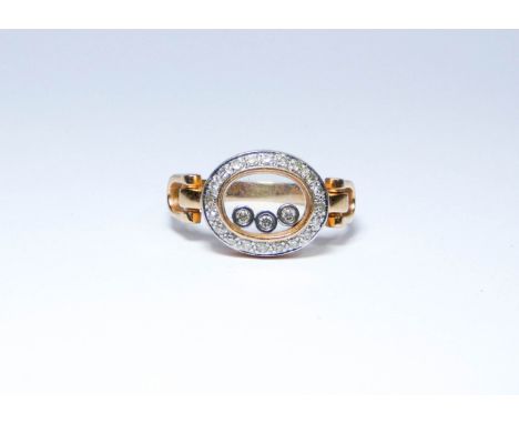An 18ct diamond dress ring in the style of Chopard  'Happy Diamonds' with three floating diamonds, ring size L, approximate w