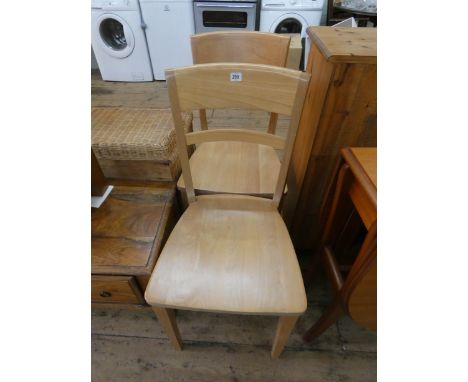 A pair of modern light beech kitchen chairs