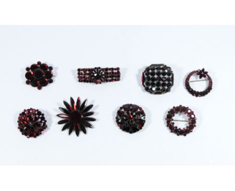 A collection of garnet look paste vintage brooches, eight in the lot