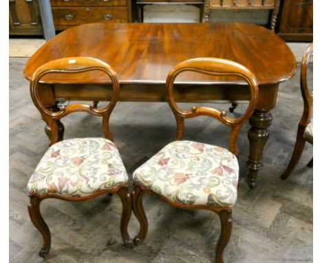 A set of six Victorian oak balloon back dining room chairs standing on cabriole legs with tapestry upholstered seats 