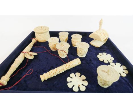 A collection of 19th Century oriental carved ivory and bone sewing collectable's to include sewing clamp bobbins, needle case