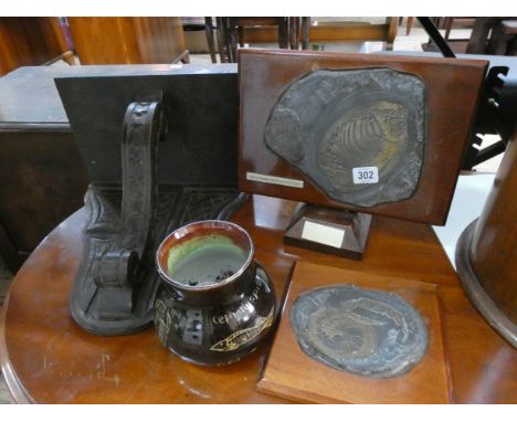 Two fossil plaques, carved oak wall bracket and a pottery vase 