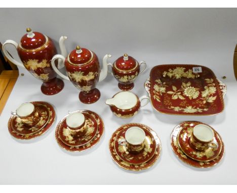 Wedgwood Ruby Tonquin coffee service comprising two coffee pots of graduated sizes, covered sugar basin, cream jug, four coff