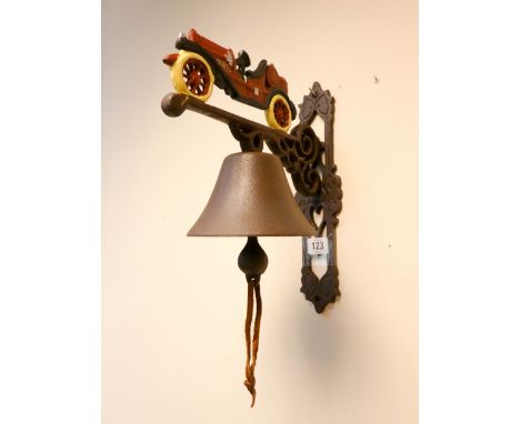 A vintage car shaped cast iron wall hanging bell 