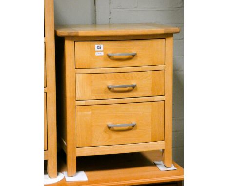 A pair of heavy quality light oak bedside chests, each fitted three drawers, mating the previous lot 