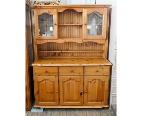 A modern light pine kitchen dresser with glazed back, three drawers and doors under, 4'6 wide 