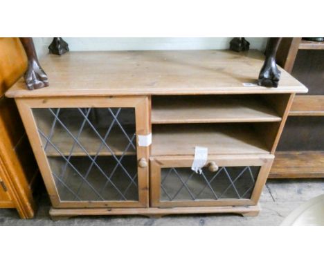 A light oak TV stand with shelves and leaded light doors under, 3'3 wide 