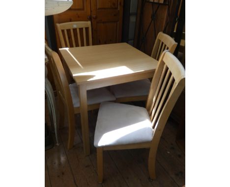 A light oak finished square kitchen or dining table with four matching slat back chairs with cream upholstered seats 