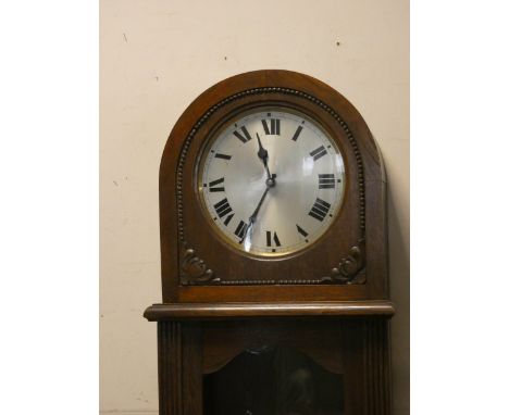 A 1930's oak and glazed case grandfather clock with circular silver dial 