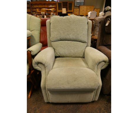 A manual reclining easy chair in pale green covering 