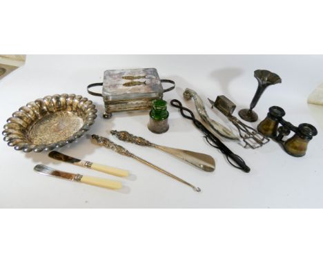 A smelling salts bottle with silver frame, silver plated sardine dish, button hook, shoe horn, silver plate, opera glasses et
