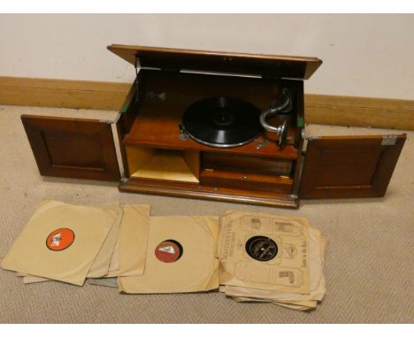 An early 20th Century wind up table model gramophone in mahogany case and a quantity of 78 records 