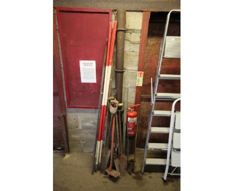 A quantity of long handled garden tools; white a red field markers etc