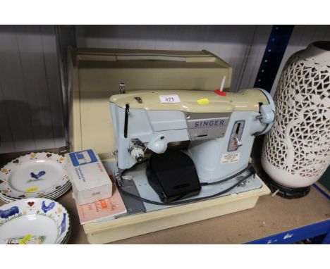 A Singer electric sewing machine in fitted case sold as collectors item