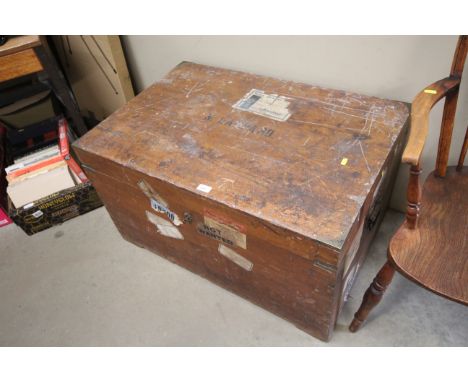 A brass bound travel trunk bearing labels 