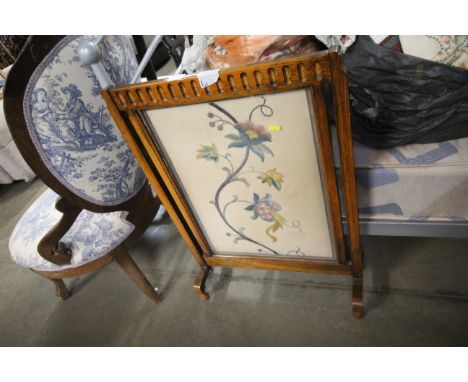 An oak and needlework fire screen 
