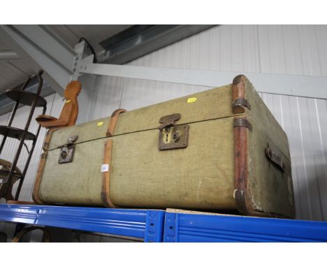 A wooden and metal bound traveling trunk 