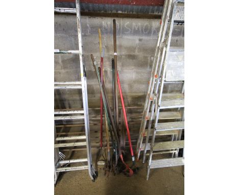 A quantity of long handled garden tools to include hoes etc