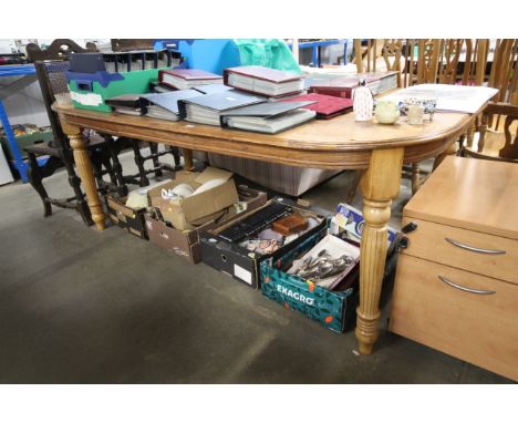 An extending dining table with one extra leaf together with a set of six stick and wheel back dining chairs comprising of two