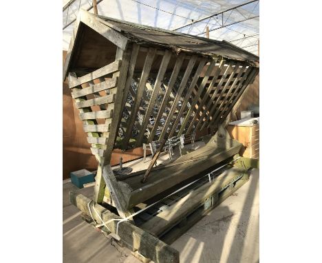 A LARGE WOODEN HAYRACK WITH TROUGH UNDERNEATH IN NEED OF REPAIR 246CM X 189CM 