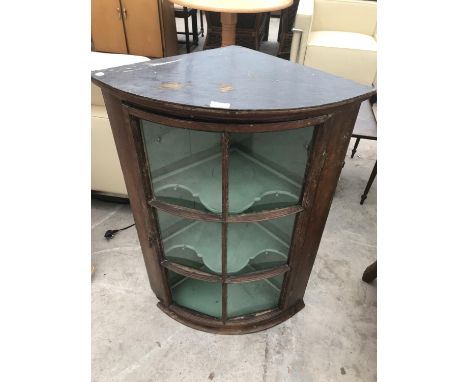 AN OAK BOW FRONT CORNER CUPBOARD WITH GLAZED PANEL DOOR 