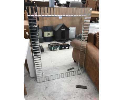 A RECTANGULAR MIRROR WITH MIRRORED TILE BORDER 