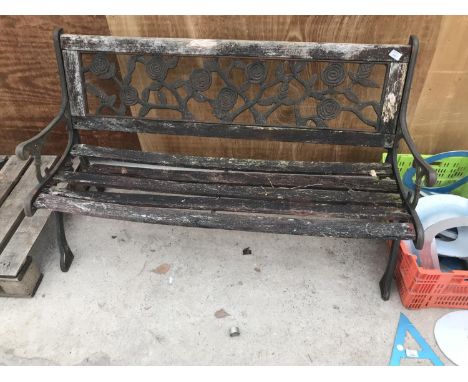 A WOODEN BENCH WITH CAST IRON ENDS AND ROSE DESIGN BACK PANEL 126CM LONG (WOOD NEEDS REPLACING) 