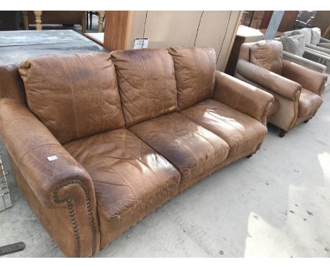 A TAN LEATHER THREE SEATER SOFA WITH MATCHING ARMCHAIR AND FOOTSTOOL 