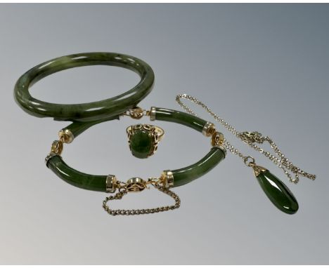 A 9ct yellow gold cabochon dark green jade ring, size N, together with jade bangle, gilt metal mounted jade bracelet and 9ct 