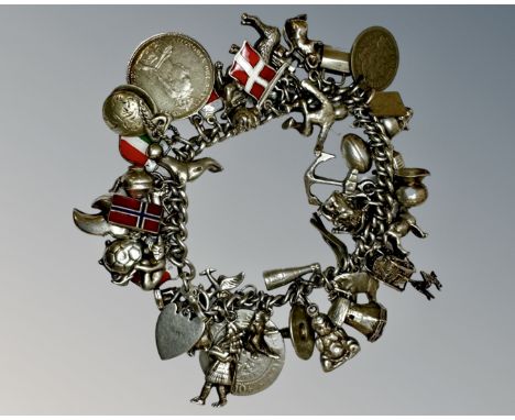 A heavy silver charm bracelet, 118.0g.