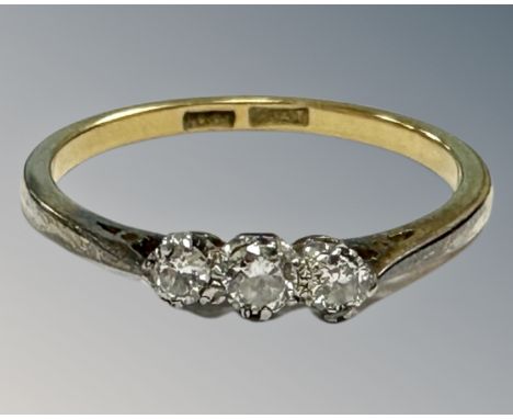 An early 20th century 18ct yellow gold and platinum set three stone diamond ring, P, 2.3g, approximately 0.2ct.