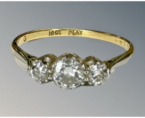 An antique 18ct gold three stone diamond ring, size P½, central stone approximately 0.4ct.