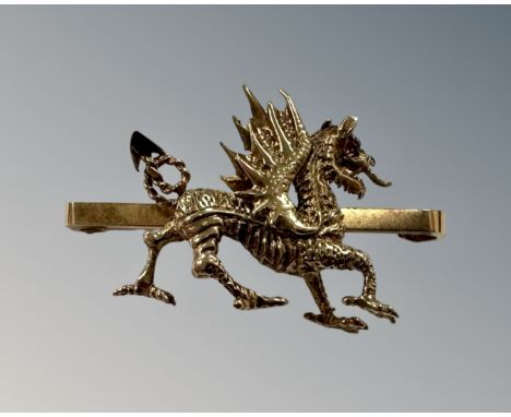 A 9ct yellow gold bar brooch modelled as a dragon, 7g, length 4 cm. CONDITION REPORT: The eye thought to be a synthetic ruby.