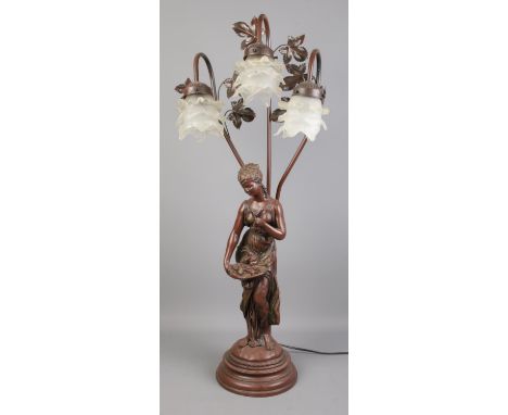 A large composite figural table lamp with background foliage and three frosted glass shades. 84cm tall.  Has not been tested.