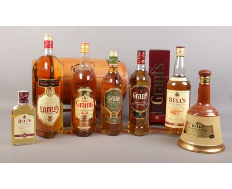 A collection of Grant's &amp; Bell's Scotch whisky. (7) To include Grant's 1.5 litre 'the family reserve' with wooden adverti