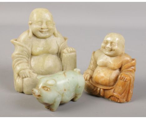 Two soapstone Buddha figures along with a carved jade coloured model of a pig.  