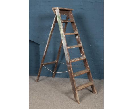 A large set of wooden step ladders.  