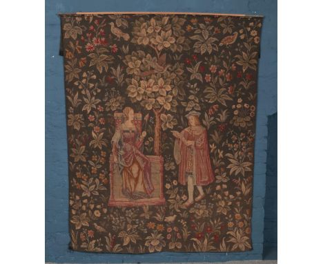 A large portrait wool tapestry depicting a man reading a scroll to a seated woman, surrounded by birds and foliage (165cm x 1