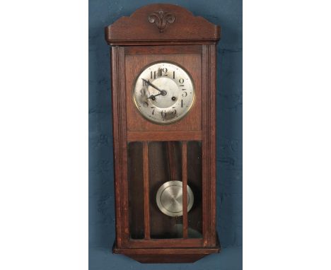 An oak cased wall clock.  