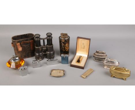 A selection of vintage lighters and pair of binoculars. To include a boxed dunhill lighter, Ronson and Colibri examples etc. 