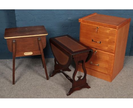 A work box with contents of sewing equipment along with a lyre support sofa table and a modern filing cabinet.  