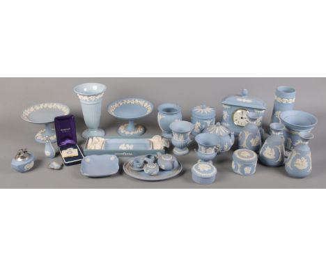 A quantity of mostly blue Wedgwood jasperware. Including miniature teaset, cylinder vase, trinket boxes, mantel clock, etc.  