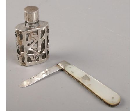 An early 20th century mother of pearl and silver fruit knife, along with a silver mounted glass scent bottle.  