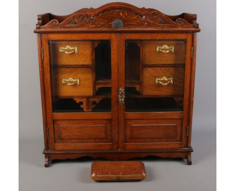 An oak smokers cabinet with bevelled glass panel doors along with a Bayley &amp; Holdsworth pipe case.  